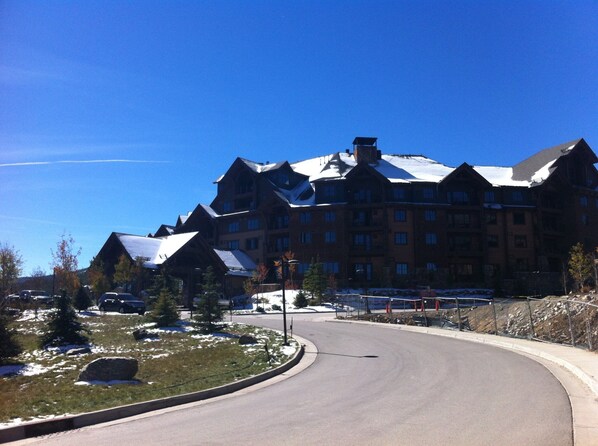 A large, multi-story hotel with a snow-covered roof and a curved driveway.