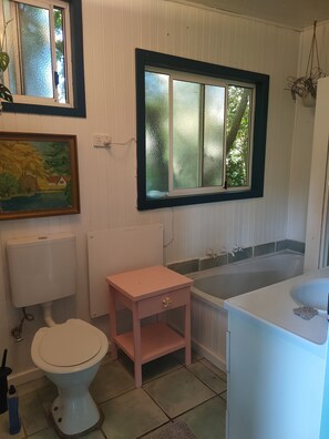 Bathtub, towels, soap, toilet paper