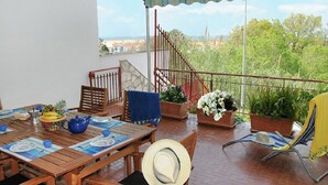 A wooden table set with plates, a teapot, and a hat.