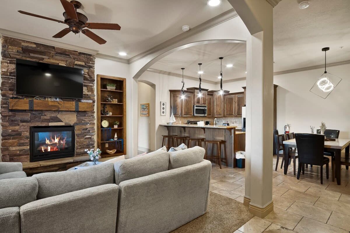 A living room with a fireplace, a television, and a sofa.