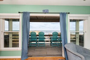 Enjoy the ocean view from your deck with a table and Adirondack chairs.