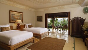 A hotel room with two beds, a wooden headboard, a large window, and a view of greenery outside. - Villa Inka Ubud by Nakula (Ubud)