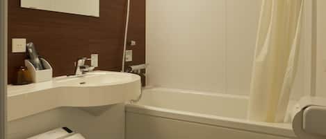 A bathroom with a toilet, sink, and bathtub.