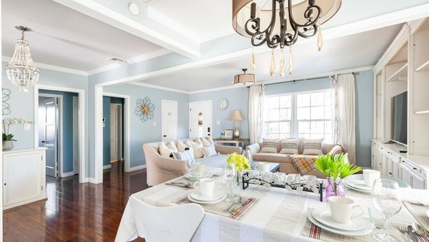 A spacious living room with a dining area, a chandelier, and a large window. - Amazing & Relaxing 5B3B-Private Pool (Monrovia)