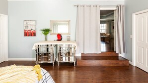 A bedroom with a bed, a nightstand, a mirror, and a window with curtains. - Amazing & Relaxing 5B3B-Private Pool (Monrovia)