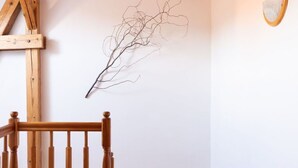 A wooden staircase with a handrail leading to a landing.