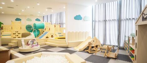 A children's play area with a ball pit, slides, and climbing structures.