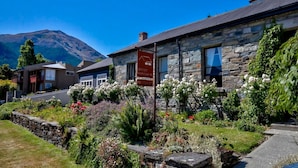 A stone building with a sign reading "History Stonehouse." - Historic Stone Cottage Apt 1- spa - 3 min from town (Queenstown)