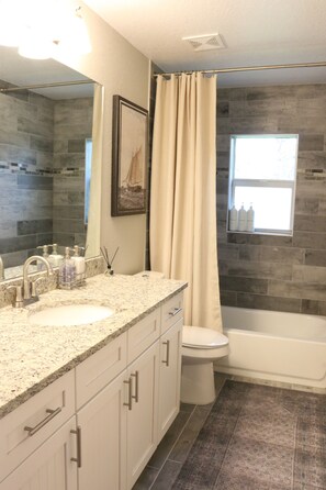 Combined shower/tub, hair dryer, towels, soap