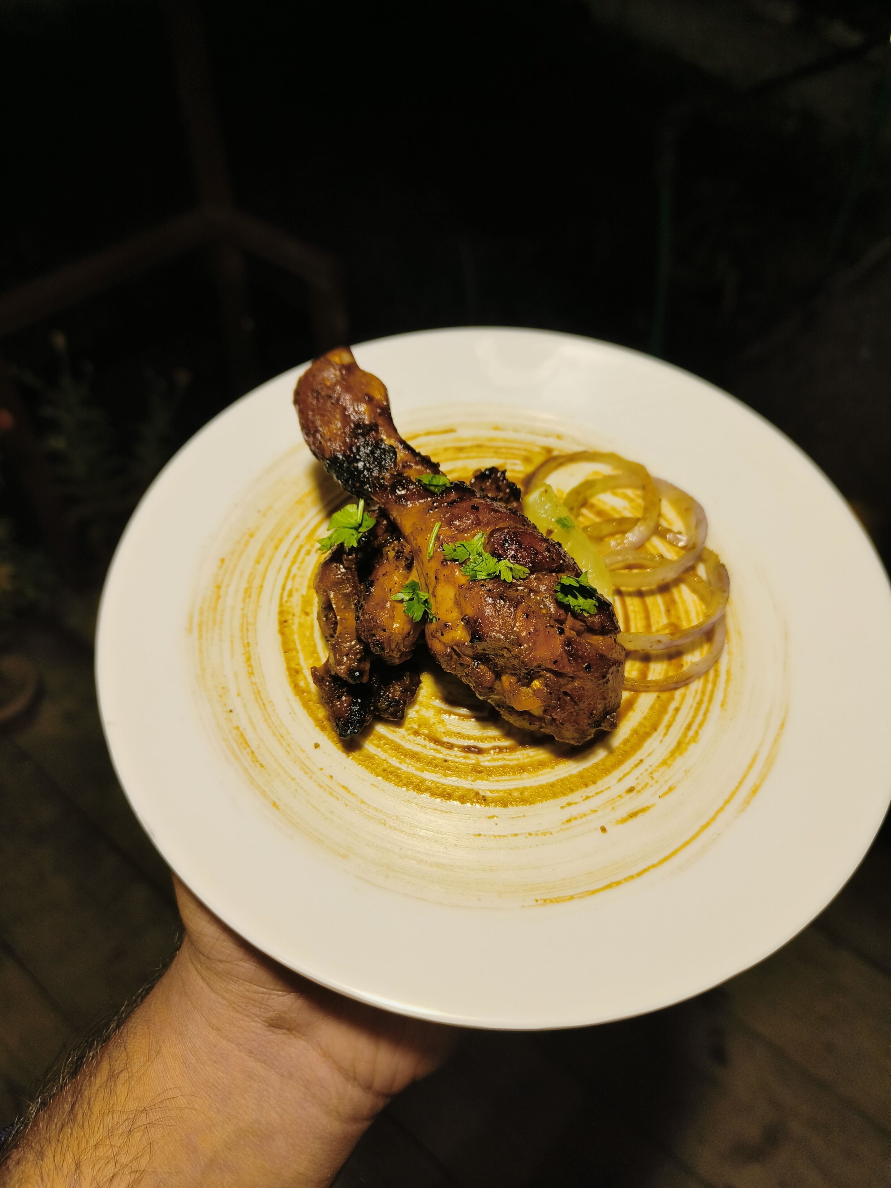 A plate with grilled chicken and onions.