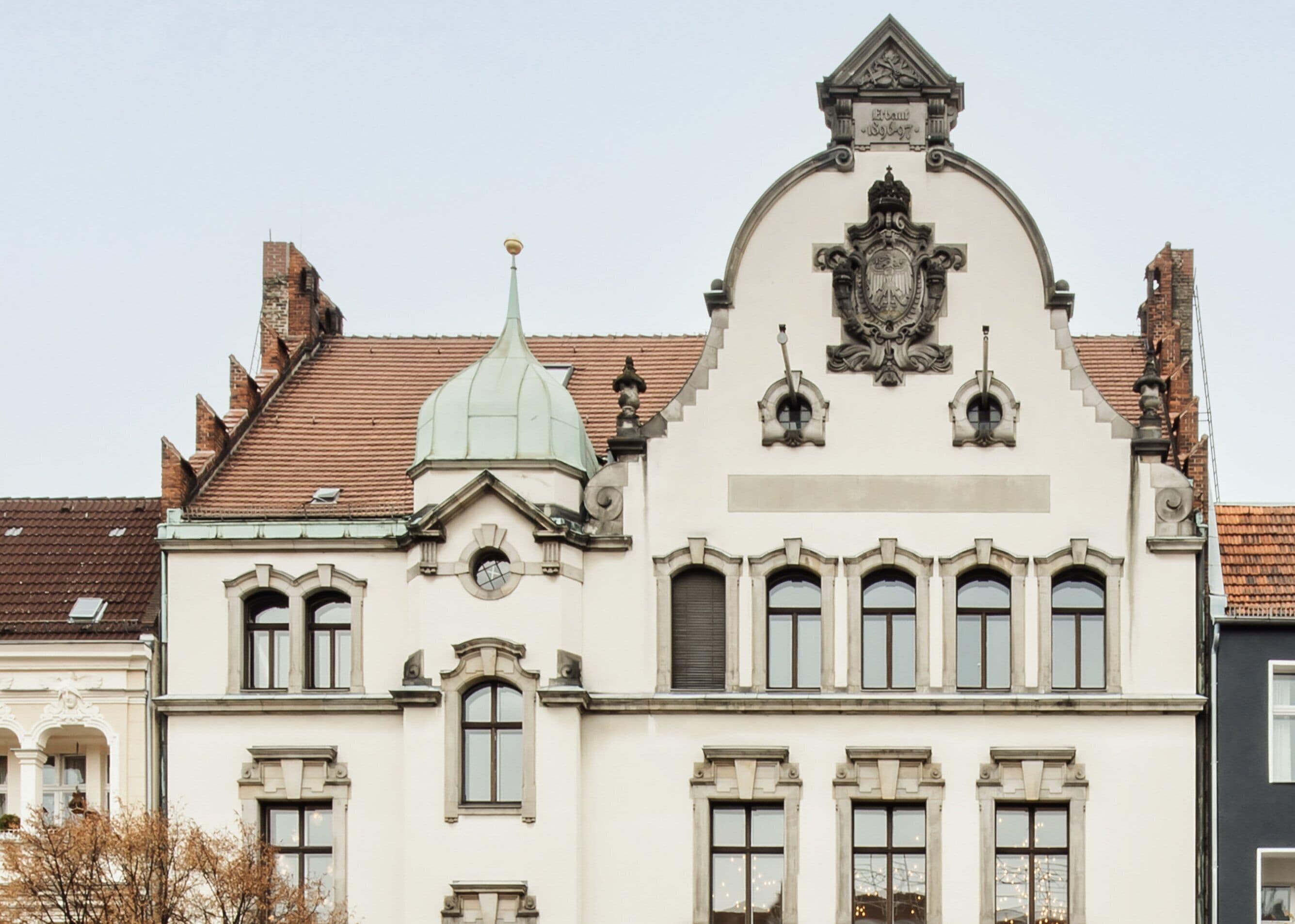 A historic building with a prominent central dome, arched windows, and a detailed facade.