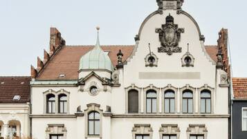 A historic building with a prominent central dome, arched windows, and a detailed facade.