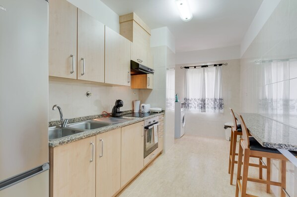 Apartment | Private kitchen | Cleaning supplies, dining tables