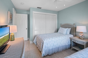 A bedroom with a bed, a television, a nightstand, and a wardrobe. - Waterfront 3BR Marco Island home with heated pool and WiFi. (Marco Island)