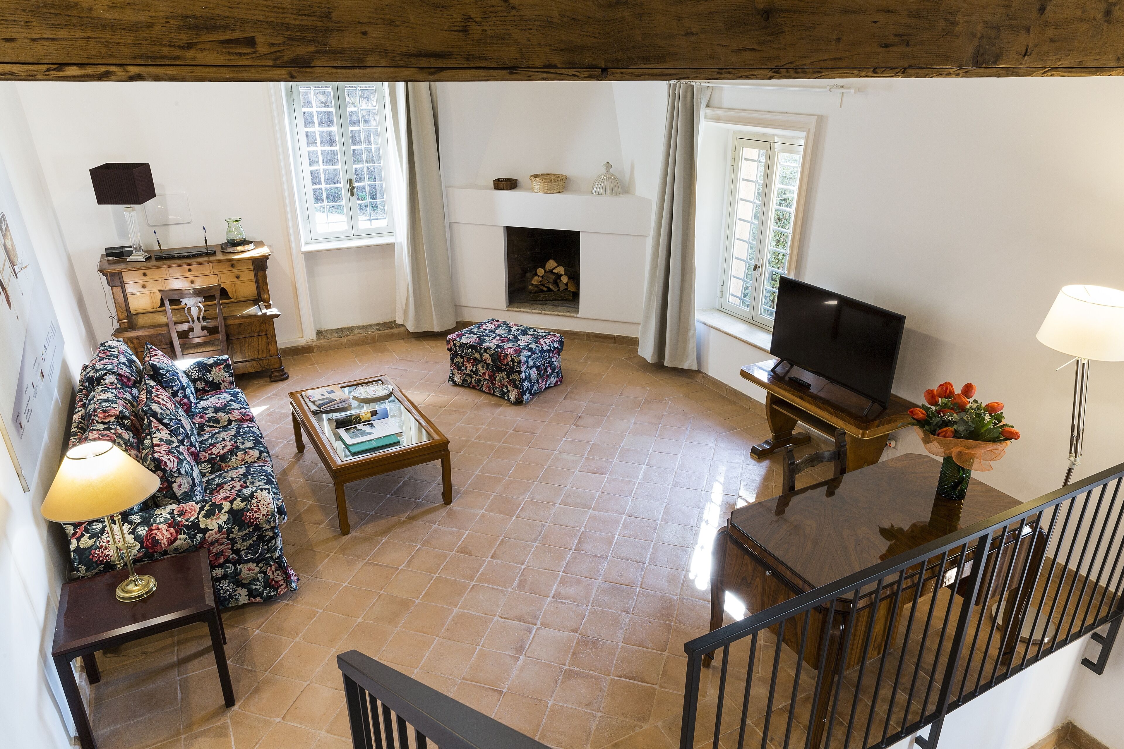 Un salon avec une cheminée, un canapé, une table basse et un téléviseur.