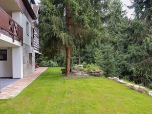 A modern two-story building with a stone facade and a well-maintained lawn.