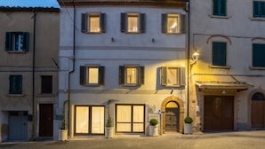 A building with multiple windows, a large arched entrance, and a street lamp.