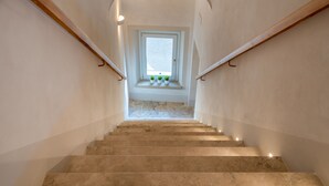 A staircase with a view of a window at the top.
