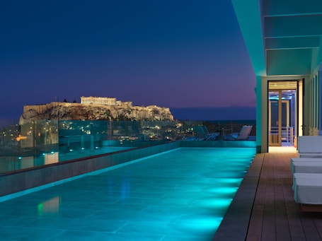 Indoor pool, seasonal outdoor pool, pool umbrellas, sun loungers. NYX Esperia Palace Hotel Athens