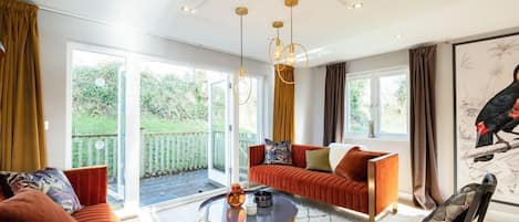 A modern living room with a sofa, a coffee table, and a painting on the wall.