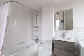 Bathtub, hair dryer, towels, soap