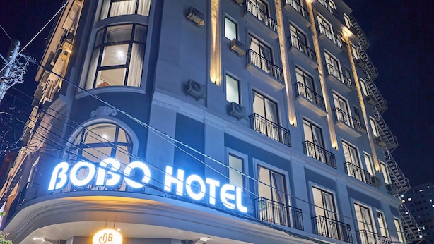 A hotel with a prominent sign reading "BOBO HOTEL" and a visible entrance with a glass facade. - BOBO Boutique Hotel (Ho Chi Minh City)