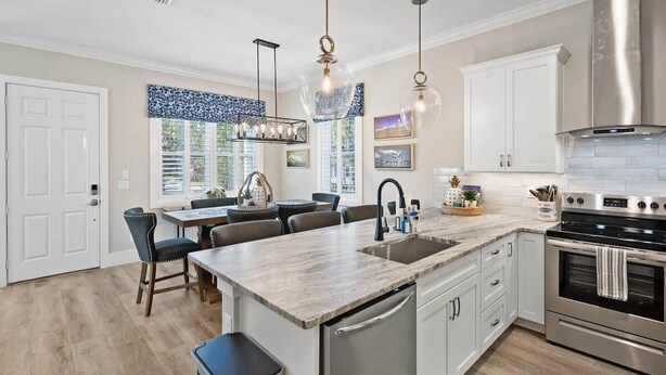 A modern kitchen with a central island, stainless steel appliances, and pendant lighting. - Steps to Ice Plant, in Downtown St Augustine (St. Augustine)
