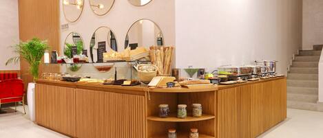 A breakfast bar with wooden paneling, multiple mirrors, and jars of condiments.