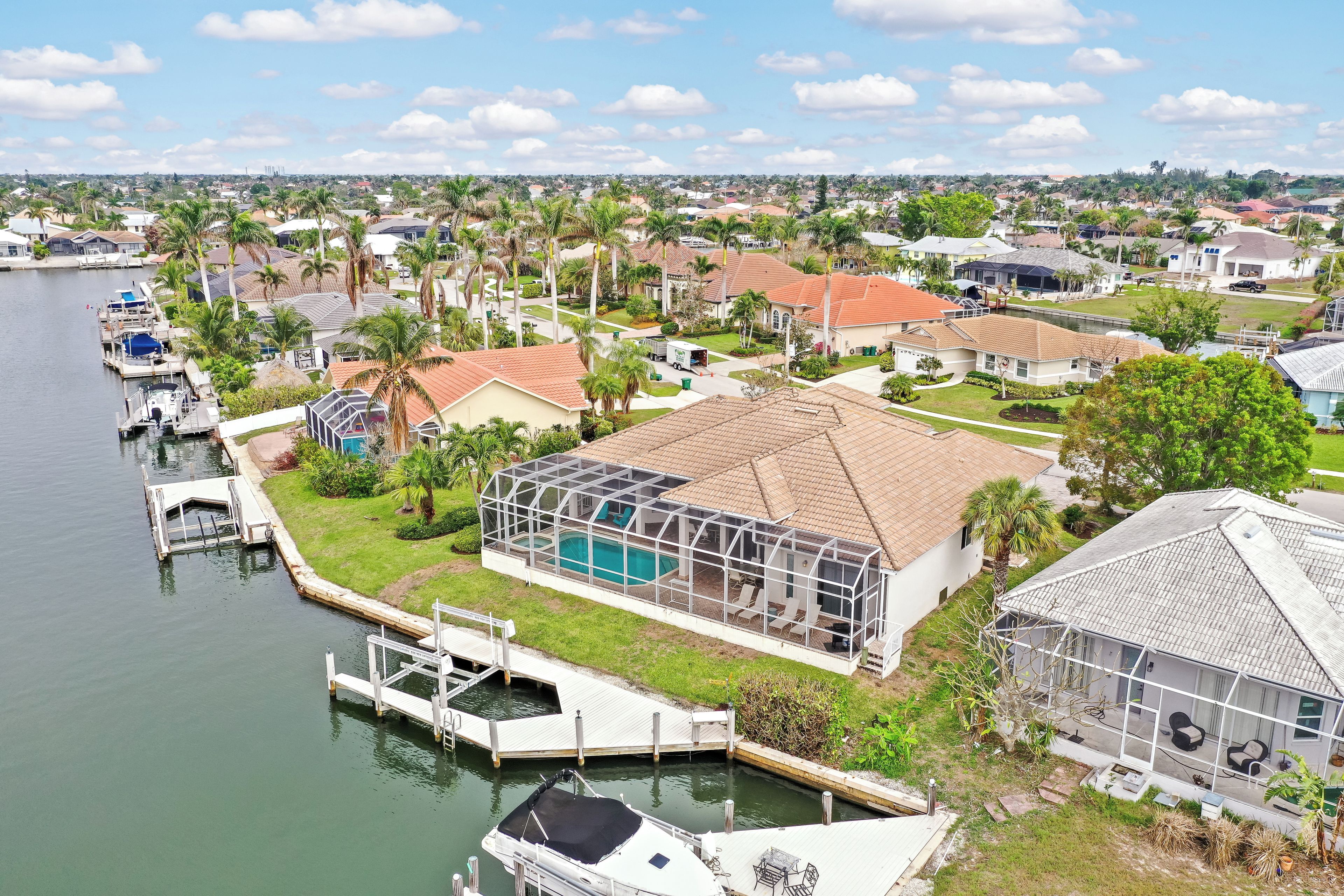 A residential area with houses, a dock, and a swimming pool.