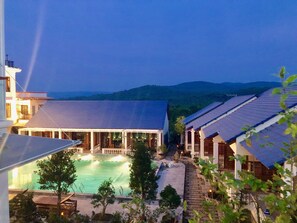 A resort with a swimming pool, a covered patio, and traditional architecture. - THE LANDING RESORT PHU QUOC (Phu Quoc)