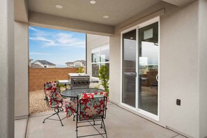 Enjoy al fresco dining on the patio, complete with a barbecue grill and comfortable seating.