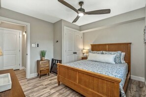 Cozy retreat with a large bed, nightstand, and dresser, perfect for a restful stay.