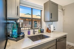 Enjoy a kitchen with a large window, stainless steel appliances, and a sink, perfect for preparing meals.