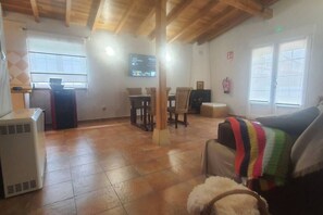 Ein Wohnzimmer mit Kamin, Fernseher und Essbereich.