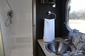 Airstream 23' International RBT | Living area | 15-inch flat-screen TV with digital channels, TV, DVD player - Roam and Board (Carlsbad)