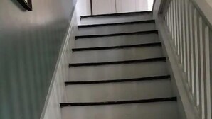 A staircase with white walls and dark steps, leading upwards. - The Red Mill House (Goldsboro)