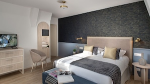 A modern bedroom with a large bed, a TV, a desk, and a chair. - Maison Douaud Vannes (Vannes)