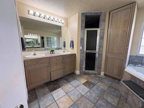 Primary bathroom with a double vanity and glass shower