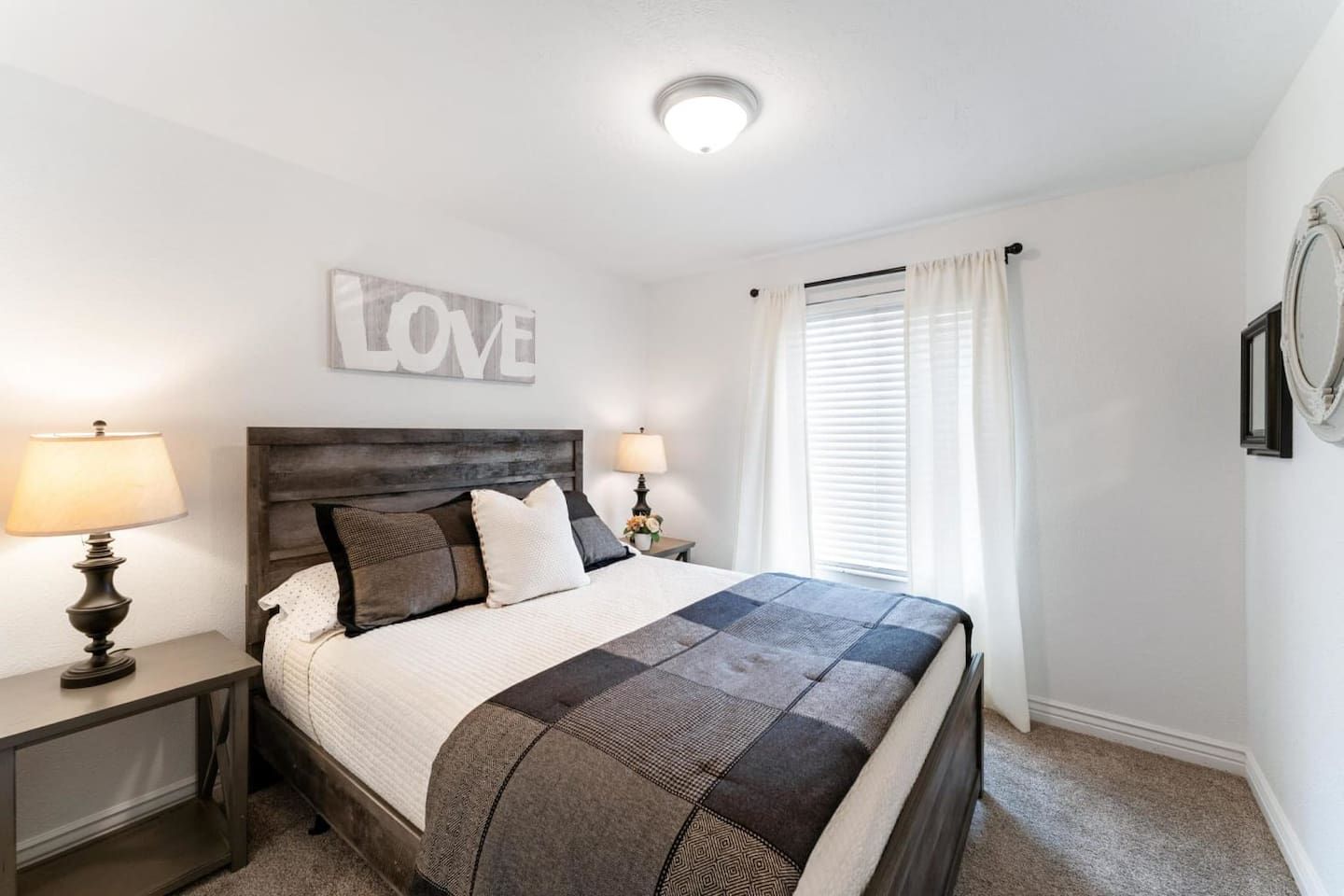 Main floor queen bedroom with a rustic wood headboard