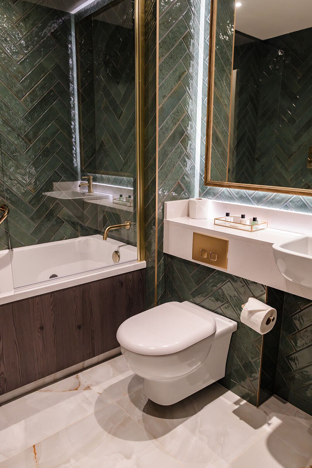 A modern bathroom with a freestanding bathtub, a toilet, and a vanity with a mirror.