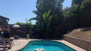 A swimming pool with inflatable floats and a person in the water. - Pool & Oceanview, Spacious 4bdrm 2 1/2 ba in a very nice neighborhood. (San Diego)
