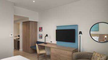 A modern bedroom with a bed, a desk, a chair, a wardrobe, and a large mirror.