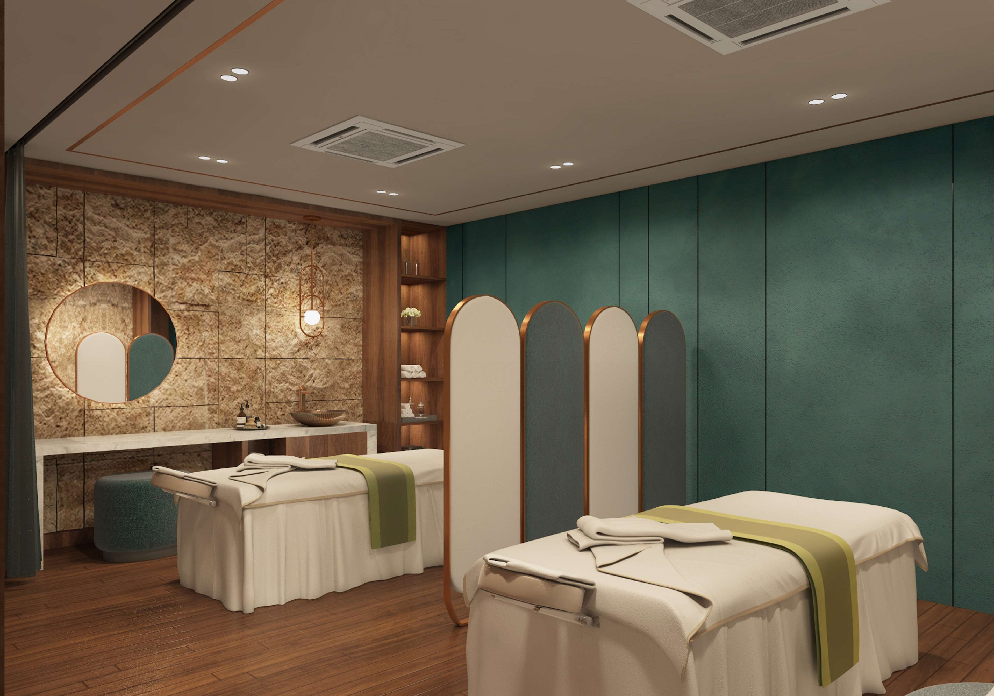 A modern spa room with a massage table, a small seating area, and a vanity with a mirror.