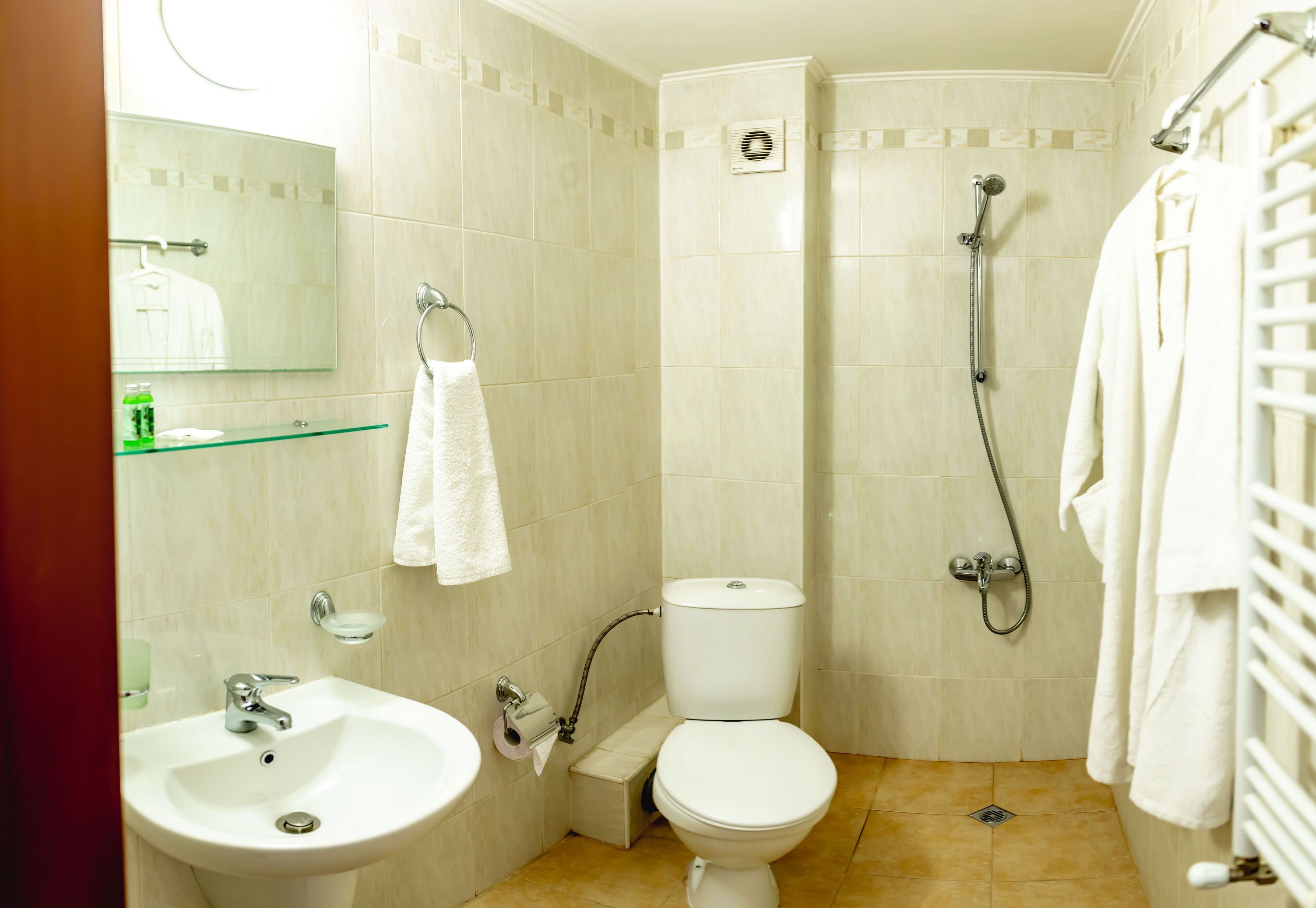 A bathroom with a sink, toilet, and shower.