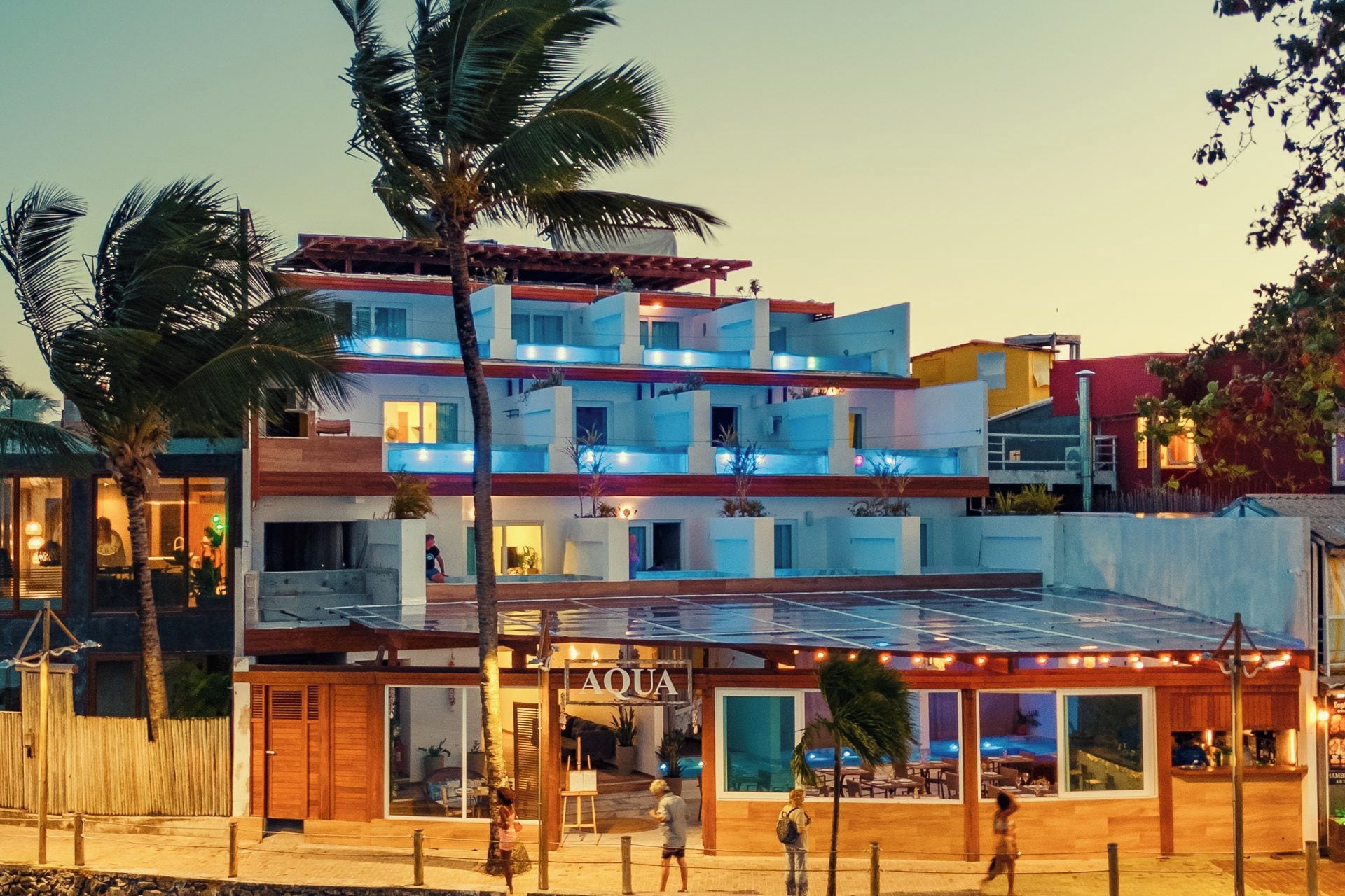 A multi-story hotel with a restaurant named 'AQUA' on the ground floor.