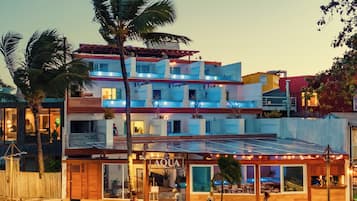 A multi-story hotel with a restaurant named 'AQUA' on the ground floor.