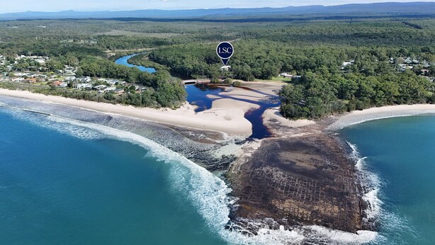 An aerial view of a coastal area with a beach, a river, and a forested area marked with an LSC logo. - Husqi Loft - by Latitiude South Coast (Huskisson)