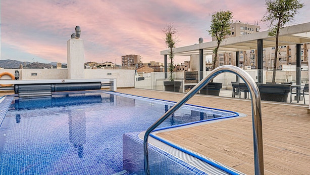 Una piscina en la azotea con vistas despejadas del paisaje urbano.