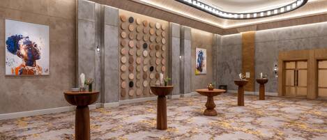 A modern hotel lobby with a marble floor, wooden columns, and a wall with circular patterns.