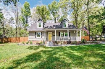 Rocking chair front porch shaded by beautiful 100+ year old oak trees
